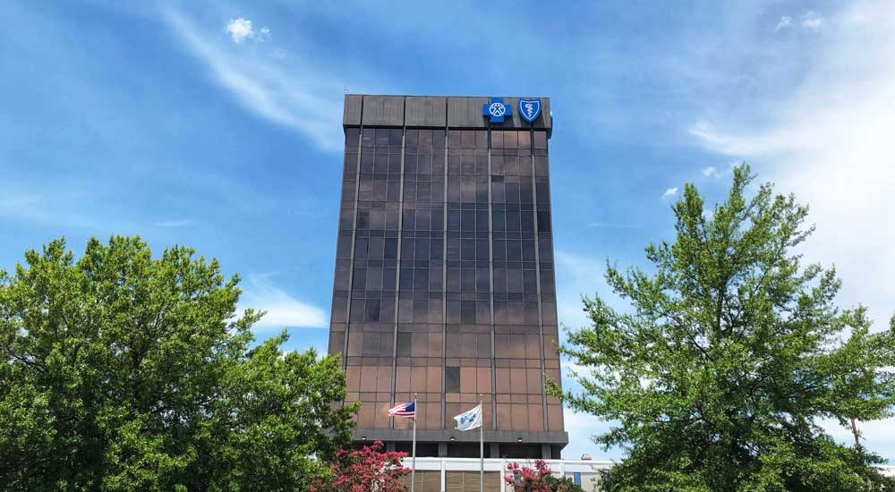 blue cross blue shield building with trees and blue sky